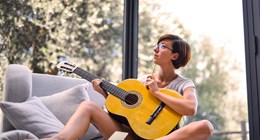 Woman holding acoustic guitar